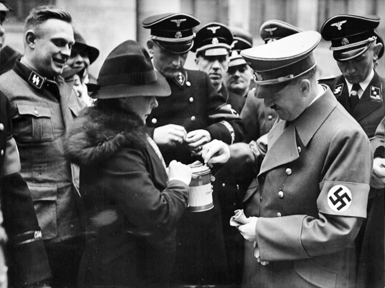 Adolf Hitler makes a contribution to the Party's Winter Relief charity in the Court of Honour at the Reich Chancellery